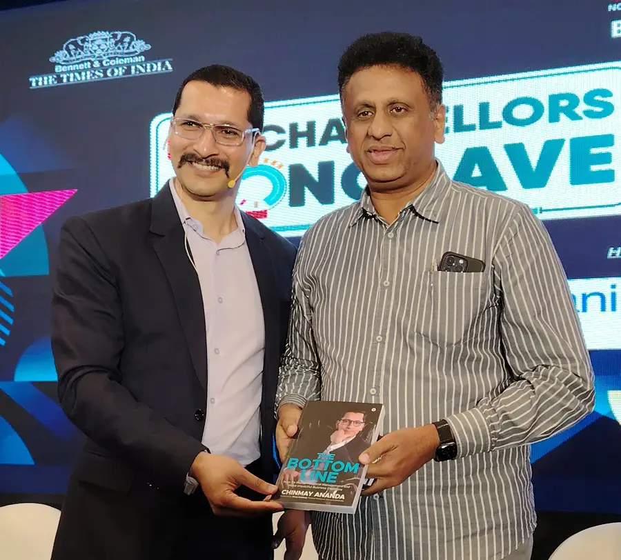 Dr. Sudhakar, Minister of Higher Education, Government of Karnataka with Chinmay Ananda's book