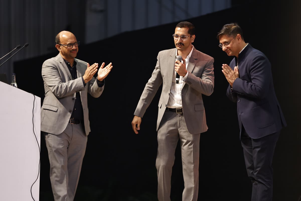 Chinmay on stage with guests during applause